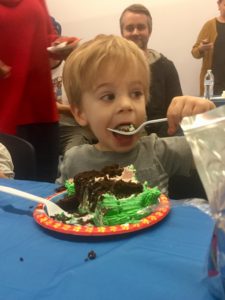 toddler eating birthday cake