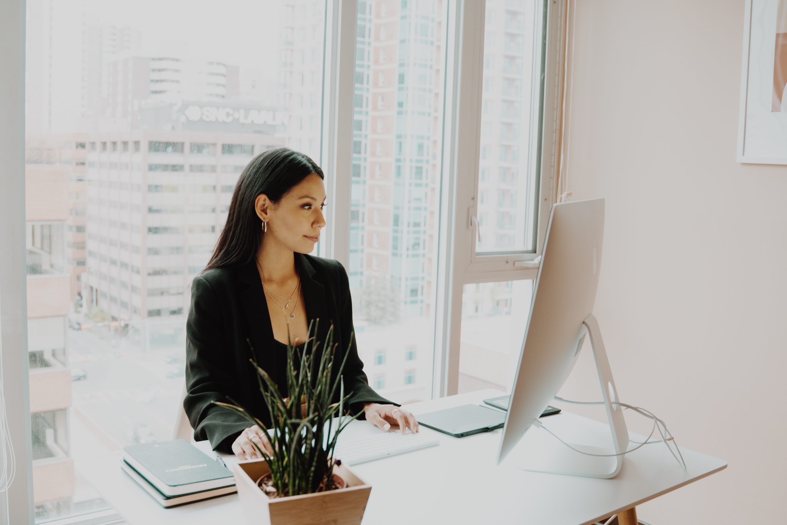 woman at her desk, working on the computer