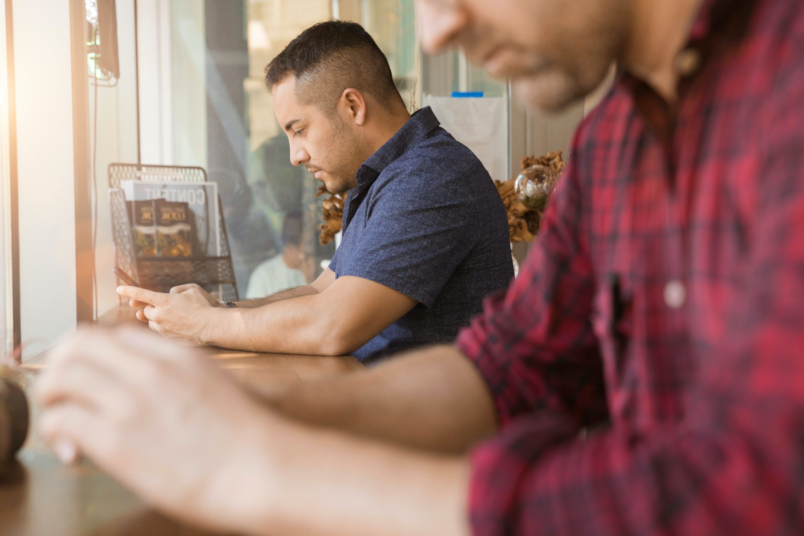 Two men using their phones