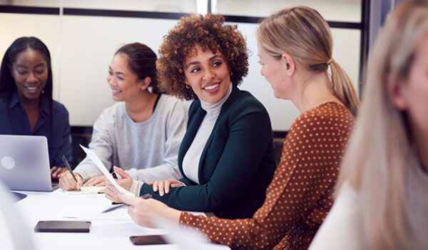 A group of women collaborating on an SEO vs PPC project.