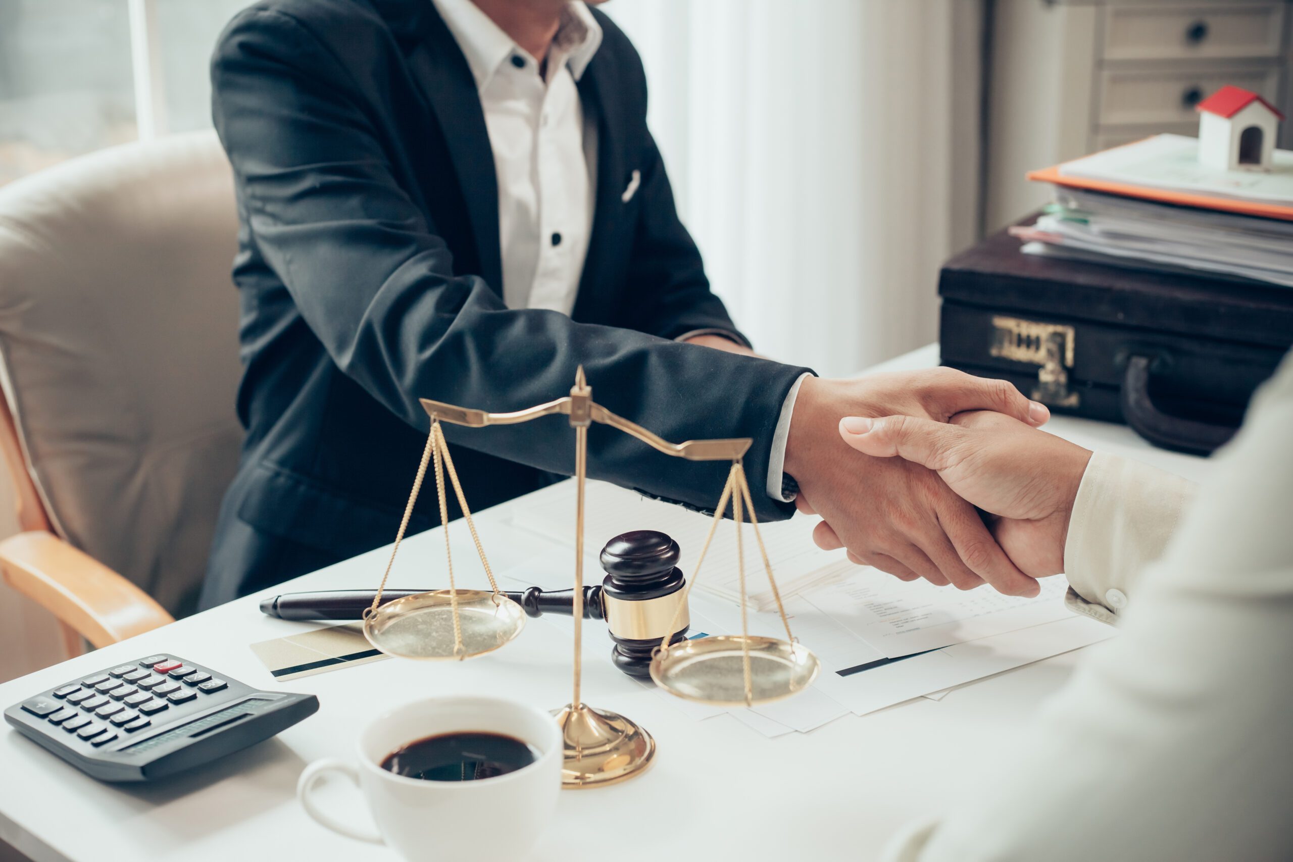 Businessman shaking hands to seal a deal with his lawyer or attorney